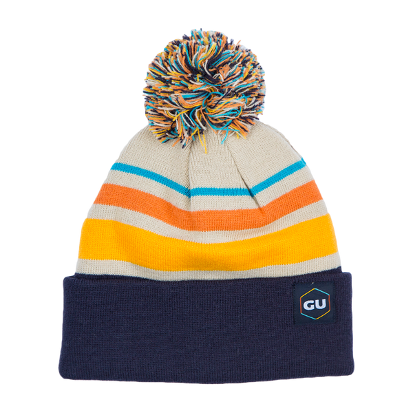 GU Energy Pom Pom Beanie in cozy knit fabric, featuring a playful pom pom on top, perfect for winter accessories.