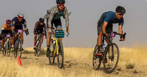 GU Energy Pom Pom Beanie in a cozy knit design, featuring a playful pom pom on top, perfect for winter accessories.