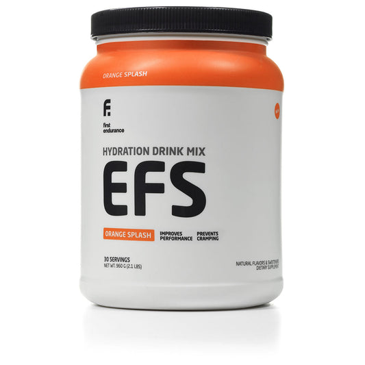 First Endurance EFS Premium Sports Energy Drink Mix in orange splash, showcasing the bottle and vibrant drink texture.