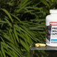 Hammer Nutrition Premium Insurance Caps multivitamin supplement bottle with capsules visible on a white background.