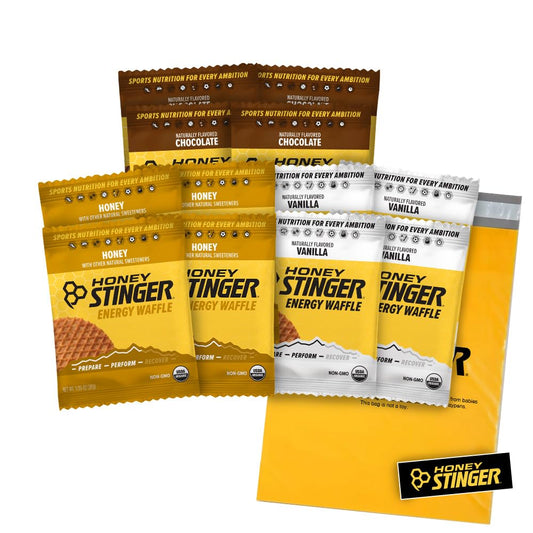 Honey Stinger Organic Waffles Variety Pack with 12 gluten-free energy waffles in honey, vanilla, and chocolate flavors, includes a sticker.
