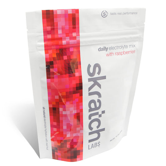 Skratch Labs Everyday Hydration Mix 1 lb container with orange flavor, showing the product label and scoop for hydration.